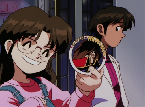 An anime girl with holding a sticker of Captain Harlock with a big smile.